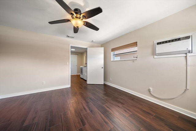 unfurnished room with visible vents, baseboards, a wall unit AC, a ceiling fan, and dark wood-style flooring