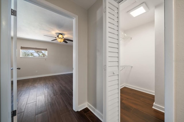 hall featuring dark wood-style floors and baseboards