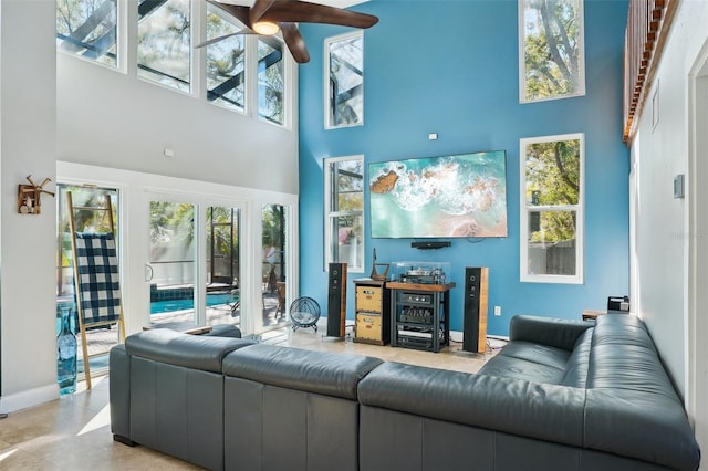 living area with baseboards and a high ceiling