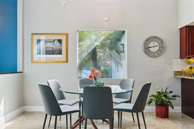 dining area featuring baseboards