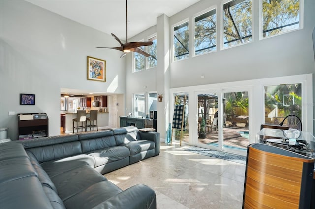 living room featuring marble finish floor and a ceiling fan