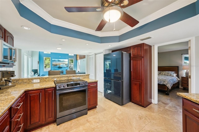 kitchen featuring visible vents, a tray ceiling, ornamental molding, stainless steel appliances, and reddish brown cabinets