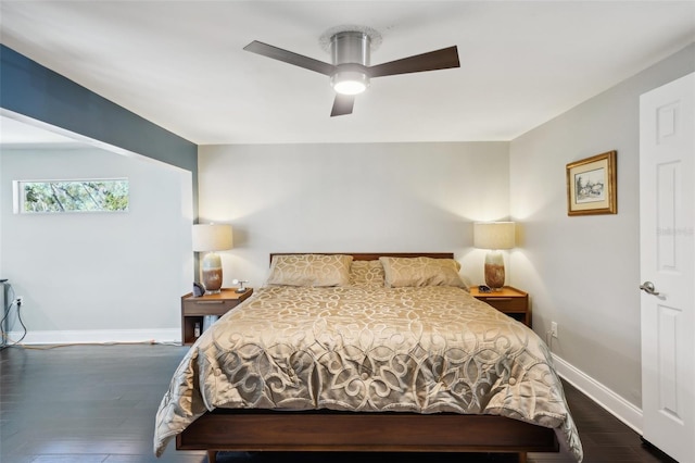 bedroom featuring baseboards, dark wood-style floors, and a ceiling fan