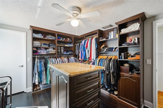 spacious closet featuring dark wood-type flooring and ceiling fan