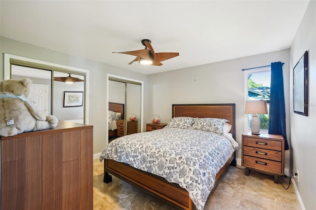 bedroom featuring a ceiling fan, baseboards, and two closets