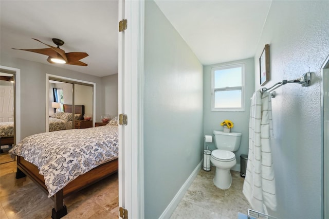 bathroom featuring toilet, a ceiling fan, connected bathroom, a shower, and baseboards