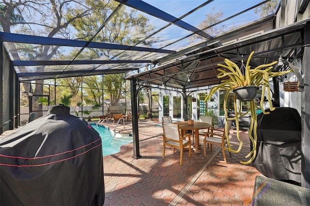 view of patio / terrace featuring a fenced in pool, area for grilling, a lanai, and fence