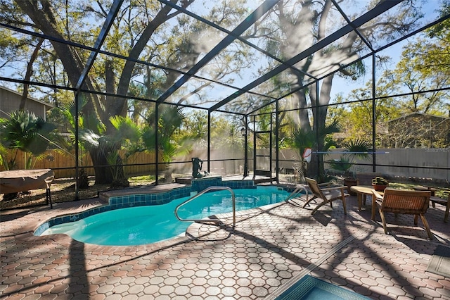 view of swimming pool featuring a patio area, a fenced backyard, a fenced in pool, and a lanai