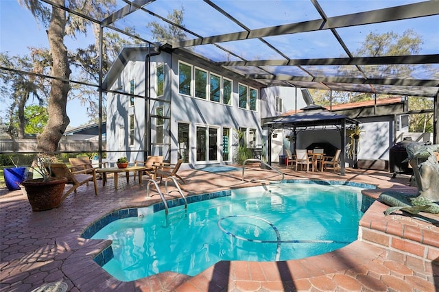 outdoor pool with a lanai and a patio area