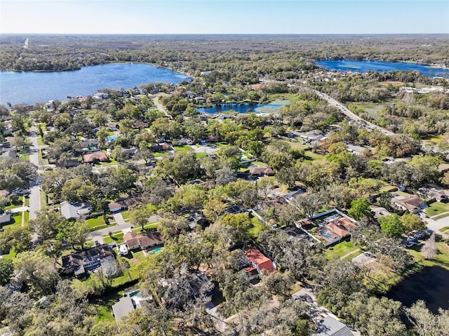 bird's eye view with a wooded view and a water view