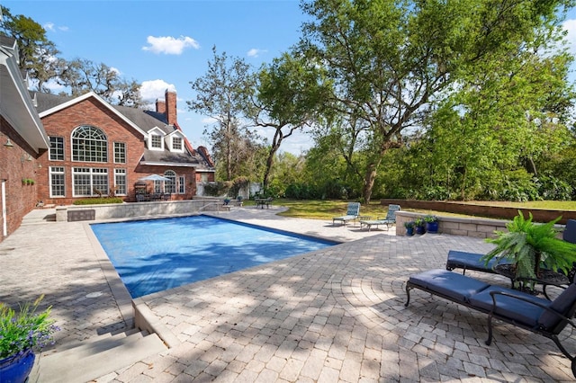 outdoor pool with a patio area