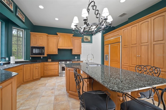 kitchen featuring custom exhaust hood, built in appliances, a kitchen island with sink, and a sink