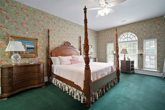 carpeted bedroom featuring visible vents, wallpapered walls, and a ceiling fan