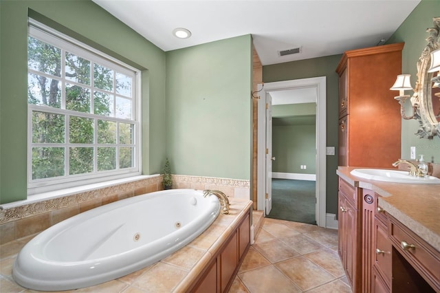 full bathroom featuring visible vents, baseboards, a whirlpool tub, tile patterned floors, and vanity