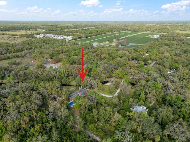 aerial view featuring a wooded view