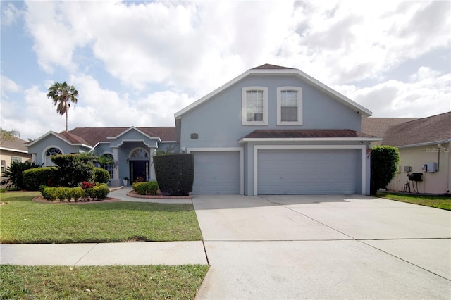 view of front of home with stucco siding, an attached garage, driveway, and a front lawn