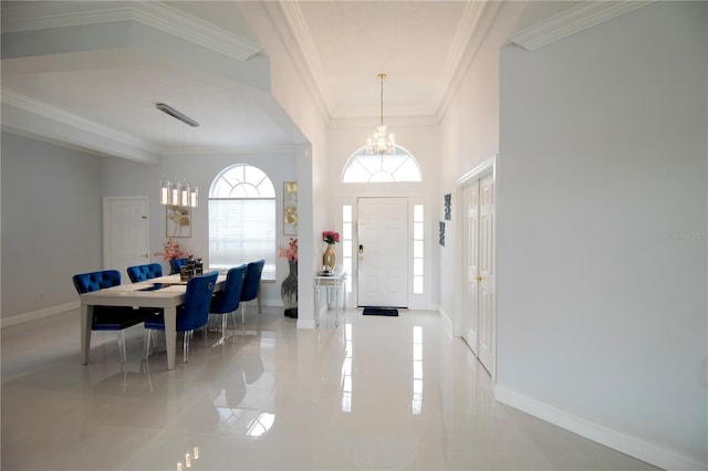 foyer entrance featuring crown molding, a notable chandelier, and baseboards