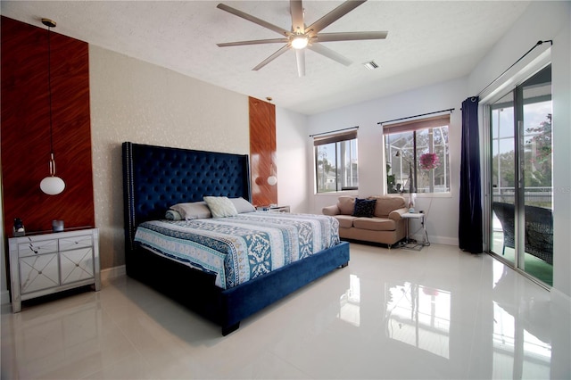 bedroom featuring baseboards, visible vents, tile patterned flooring, a textured ceiling, and access to outside