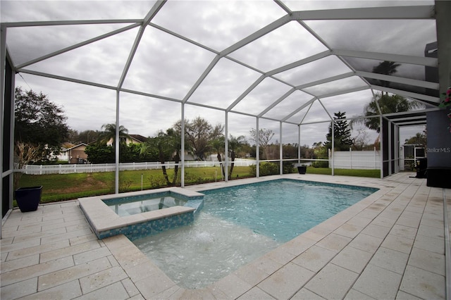 view of swimming pool with a patio, a pool with connected hot tub, a lanai, and fence