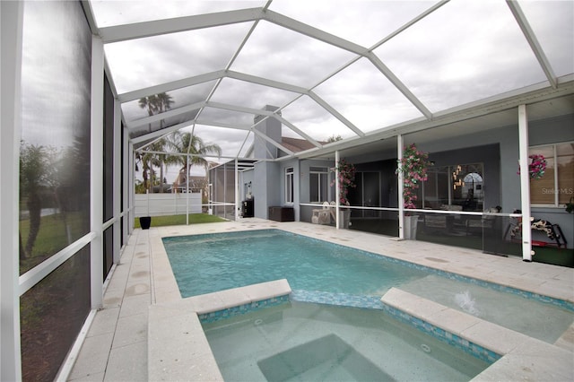 view of swimming pool featuring a patio and a pool with connected hot tub