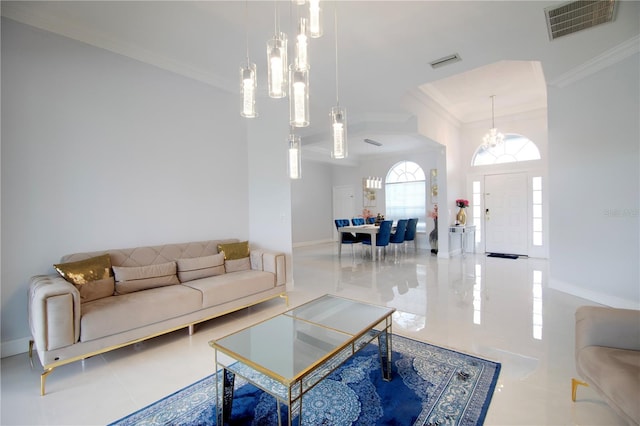 living area featuring baseboards, visible vents, and ornamental molding