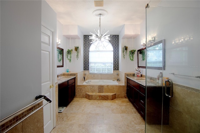 full bathroom with visible vents, a garden tub, a chandelier, and vanity