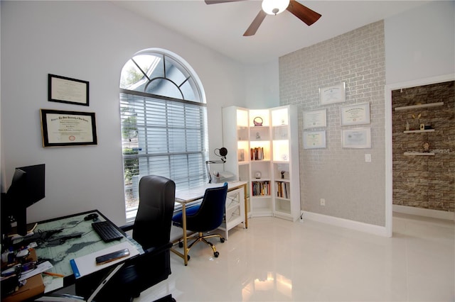 home office with light tile patterned flooring, a ceiling fan, and baseboards