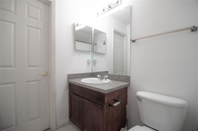 bathroom featuring toilet and vanity