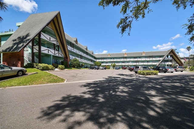 view of building exterior with uncovered parking