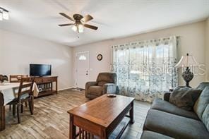 living room featuring ceiling fan and wood finished floors