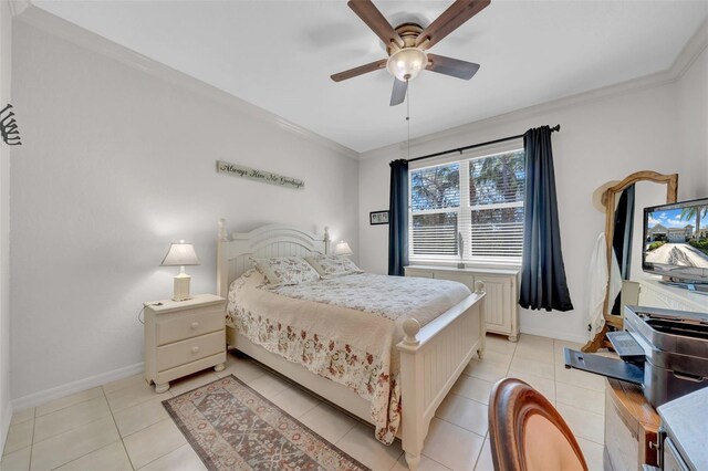 bedroom with light tile patterned floors, a ceiling fan, baseboards, and ornamental molding