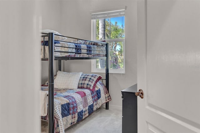 bedroom featuring carpet and baseboards