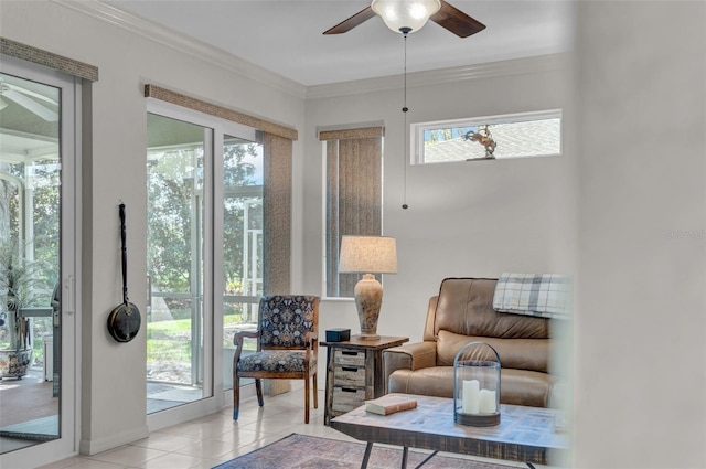 living area featuring a healthy amount of sunlight, light tile patterned flooring, a ceiling fan, and ornamental molding