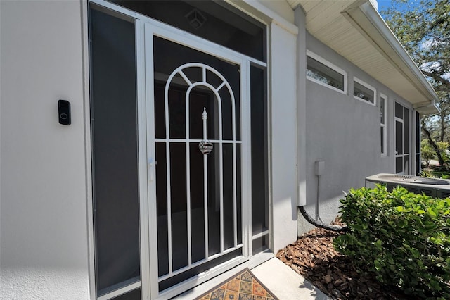 property entrance with stucco siding