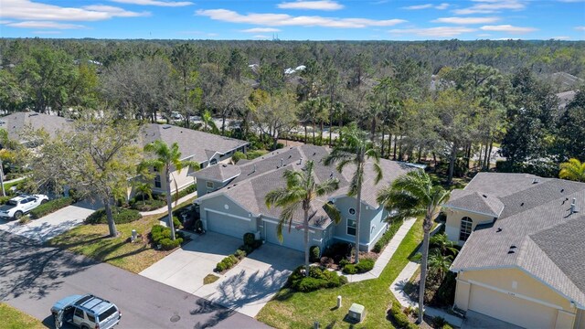 birds eye view of property featuring a wooded view and a residential view