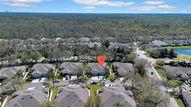 aerial view featuring a view of trees and a residential view