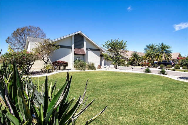 view of front of property with stucco siding and a front lawn