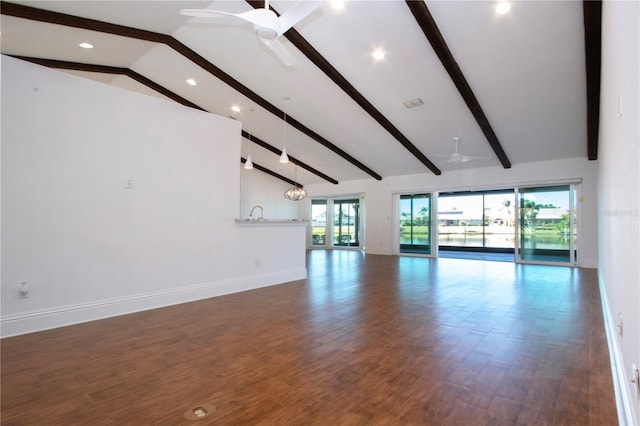 unfurnished living room with ceiling fan, baseboards, beam ceiling, wood finished floors, and high vaulted ceiling