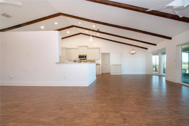 unfurnished living room featuring beamed ceiling, visible vents, and high vaulted ceiling