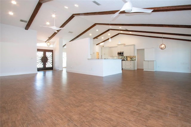 unfurnished living room with visible vents, beam ceiling, dark wood-style floors, and ceiling fan