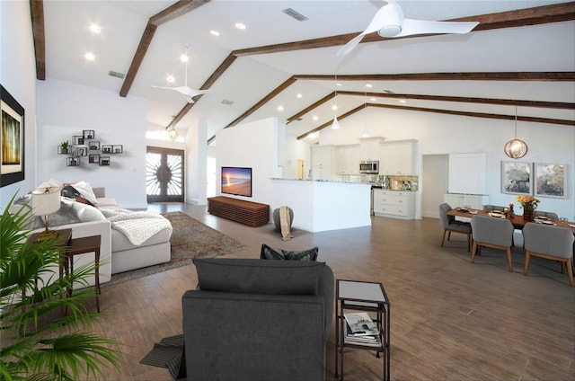 living area featuring visible vents, high vaulted ceiling, wood finished floors, and a ceiling fan