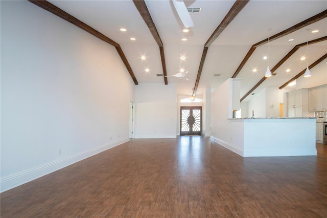 unfurnished living room featuring beamed ceiling, baseboards, dark wood-type flooring, and visible vents