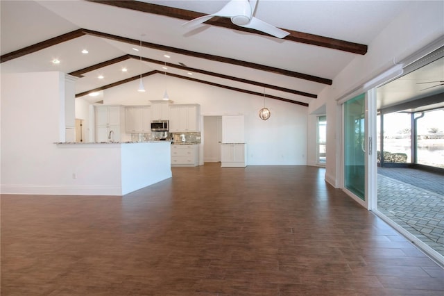 unfurnished living room featuring a ceiling fan, baseboards, high vaulted ceiling, a sink, and beamed ceiling