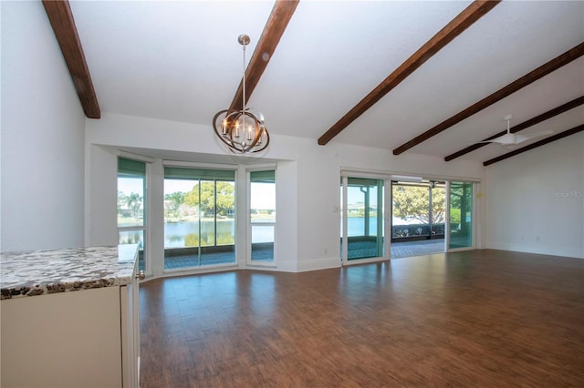 unfurnished living room featuring lofted ceiling with beams, wood finished floors, baseboards, and a chandelier