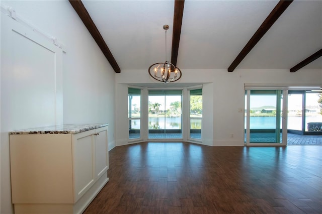 unfurnished living room with dark wood finished floors, a notable chandelier, and plenty of natural light