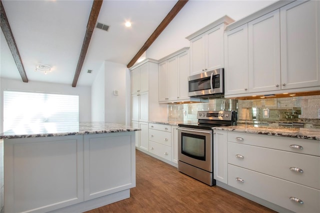 kitchen featuring visible vents, beam ceiling, light wood-style flooring, backsplash, and appliances with stainless steel finishes