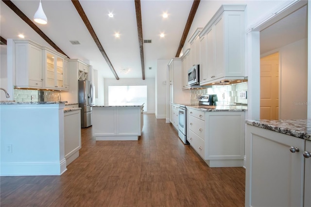 kitchen with a center island, beamed ceiling, white cabinets, and stainless steel appliances