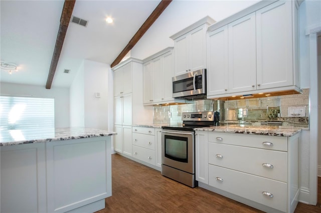 kitchen featuring visible vents, beamed ceiling, tasteful backsplash, wood finished floors, and appliances with stainless steel finishes