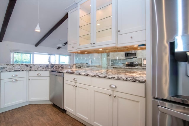 kitchen featuring wood finished floors, glass insert cabinets, appliances with stainless steel finishes, white cabinetry, and tasteful backsplash