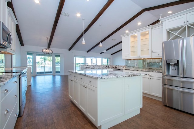 kitchen featuring lofted ceiling with beams, backsplash, dark wood-style floors, stainless steel appliances, and white cabinets